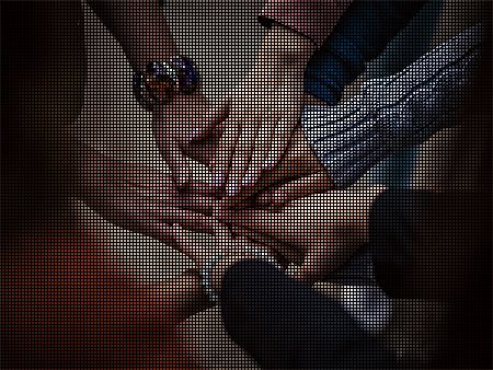 A group of people touching hands